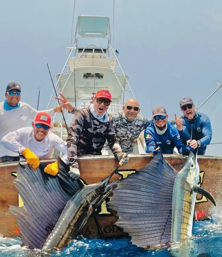 Crew and guests with a sailfish at the stern