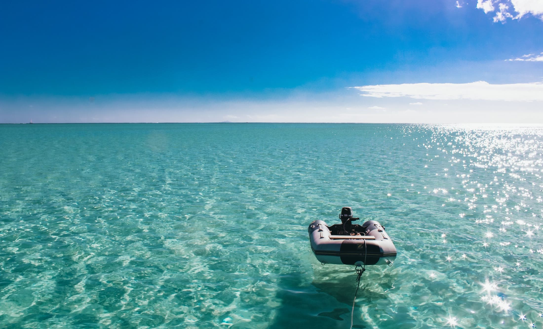 Tender adrift on crystal-clear water