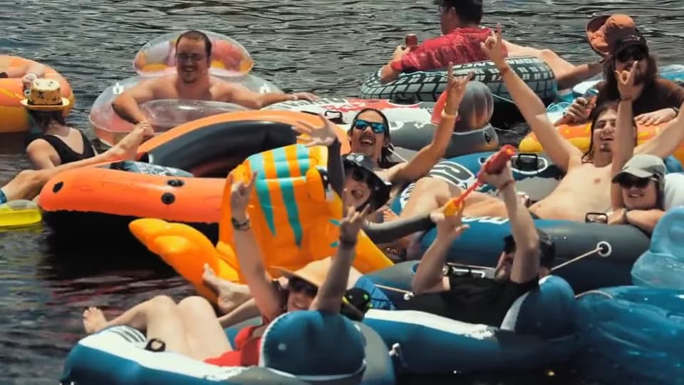 Guests gathered on a floating platform beside the yacht